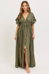 woman wearing an olive green maxi dress with a deep v-neck, short ruffled sleeves, and button details down the front