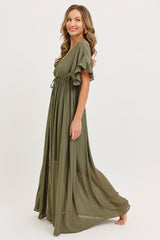 woman wearing a long olive green maxi dress with short ruffle sleeves and a cinched waist