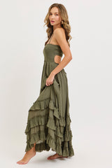 woman wearing an olive green strapless maxi dress with ruffle details and side cutouts