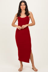 woman wearing a fitted red midi dress with a scoop neckline and side slit
