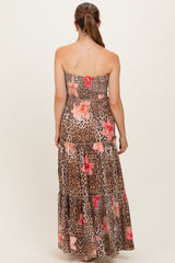 woman wearing a strapless leopard and floral print maternity maxi dress with a tiered skirt from the back