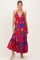 woman wearing a vibrant pink floral maternity maxi dress with a deep v-neck and ruffled hem