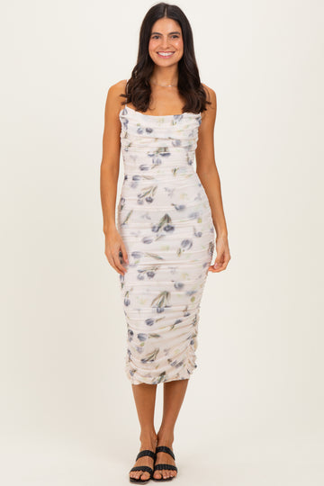 woman wearing a floral print fitted midi dress with ruched detailing and a square neckline