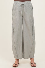 woman wearing striped wide-leg maternity pants with an elastic waistband and side pockets