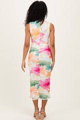 woman wearing a colorful floral print bodycon midi dress with a ruched back and sleeveless design