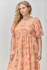 woman wearing a peach floral plus size maxi dress with puff sleeves and a square neckline
