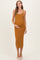 woman wearing a mustard ribbed maternity dress with a scoop neck and trim, gently holding her baby bump