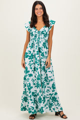 woman wearing a teal and white floral maxi dress with cap sleeves and a cinched bustline