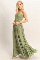 woman wearing a green maxi dress with smocked bodice and tiered ruffle details
