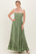 woman wearing a green strapless maxi dress with a smocked bodice and ruffled hem