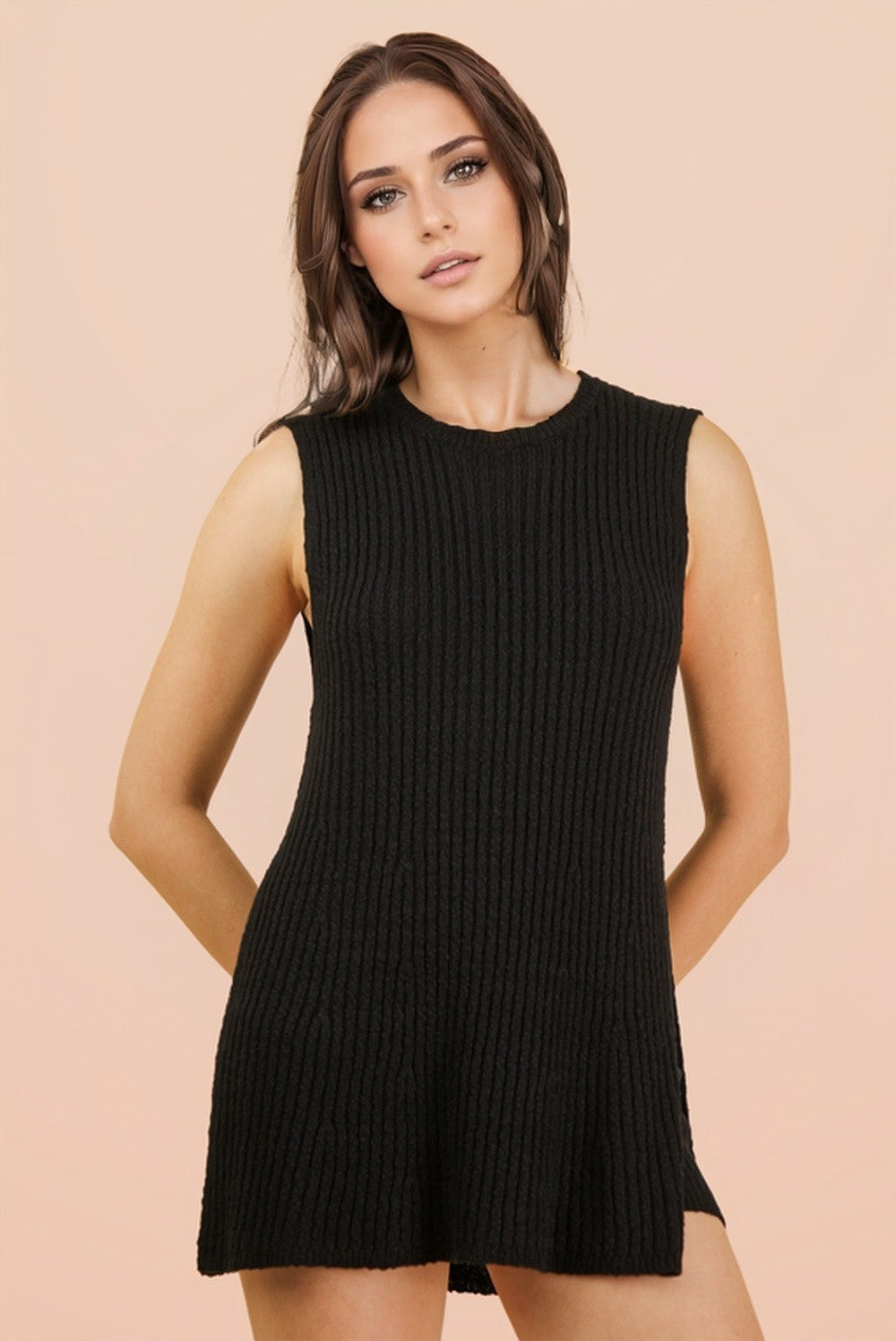 woman wearing a sleeveless black ribbed knit sweater dress with a relaxed fit