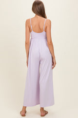 woman wearing a lavender maternity jumpsuit with wide legs and adjustable spaghetti straps, showing a baby bump
