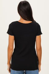 woman wearing a black short sleeve top viewed from the back with a scoop neckline and a relaxed fit