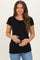 woman wearing a black short sleeve maternity top and holding her baby bump