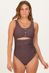 woman wearing a brown high-waisted bikini with scalloped details and button closures on the top