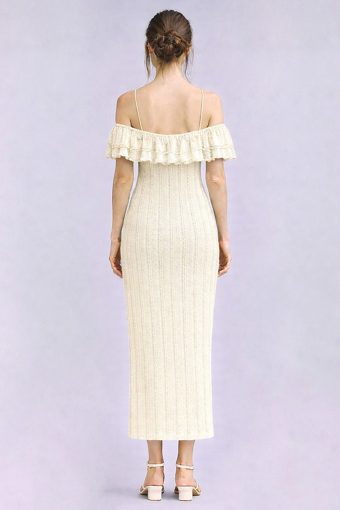 woman wearing a cream-colored off-the-shoulder ribbed maxi dress with ruffle details and a fitted silhouette