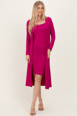 woman wearing a fitted hot pink dress with a matching long cardigan and neutral sandals