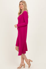woman wearing a fuchsia ribbed dress with long sleeves and a flowing silhouette, paired with beige high-heeled sandals