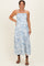 woman wearing a blue floral print maternity dress with adjustable straps and a flowy silhouette, showing her baby bump