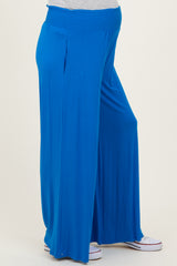 woman wearing bright blue maternity wide-leg pants with an elastic waistband and a pregnancy belly visible
