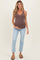 woman wearing a brown ribbed maternity tank top and light blue cropped jeans, showing her baby bump