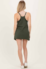 woman wearing a dark green sleeveless casual dress with a relaxed fit and scooped back