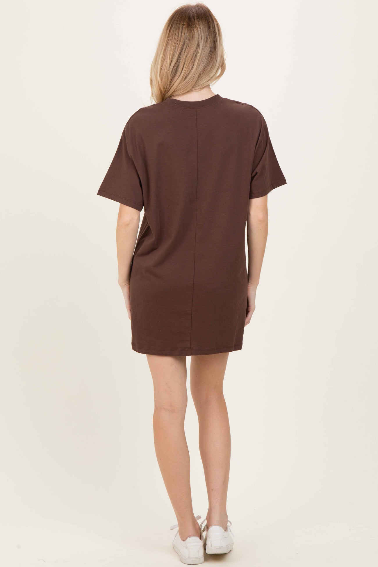 woman wearing a brown short sleeve casual dress, shown from the back, with a relaxed fit and above-the-knee length