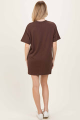 woman wearing a brown short sleeve casual dress, shown from the back, with a relaxed fit and above-the-knee length