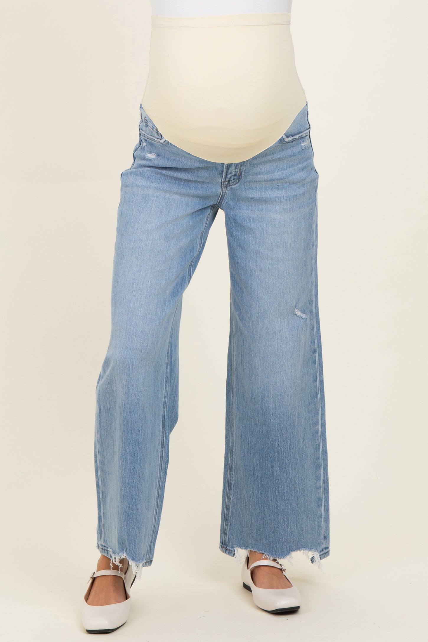 woman wearing light blue wide-leg maternity jeans with a maternity belly band
