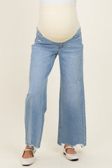 woman wearing light blue wide-leg maternity jeans with a maternity belly band