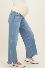 woman wearing light blue maternity wide-leg jeans with a built-in belly band and a visible baby bump