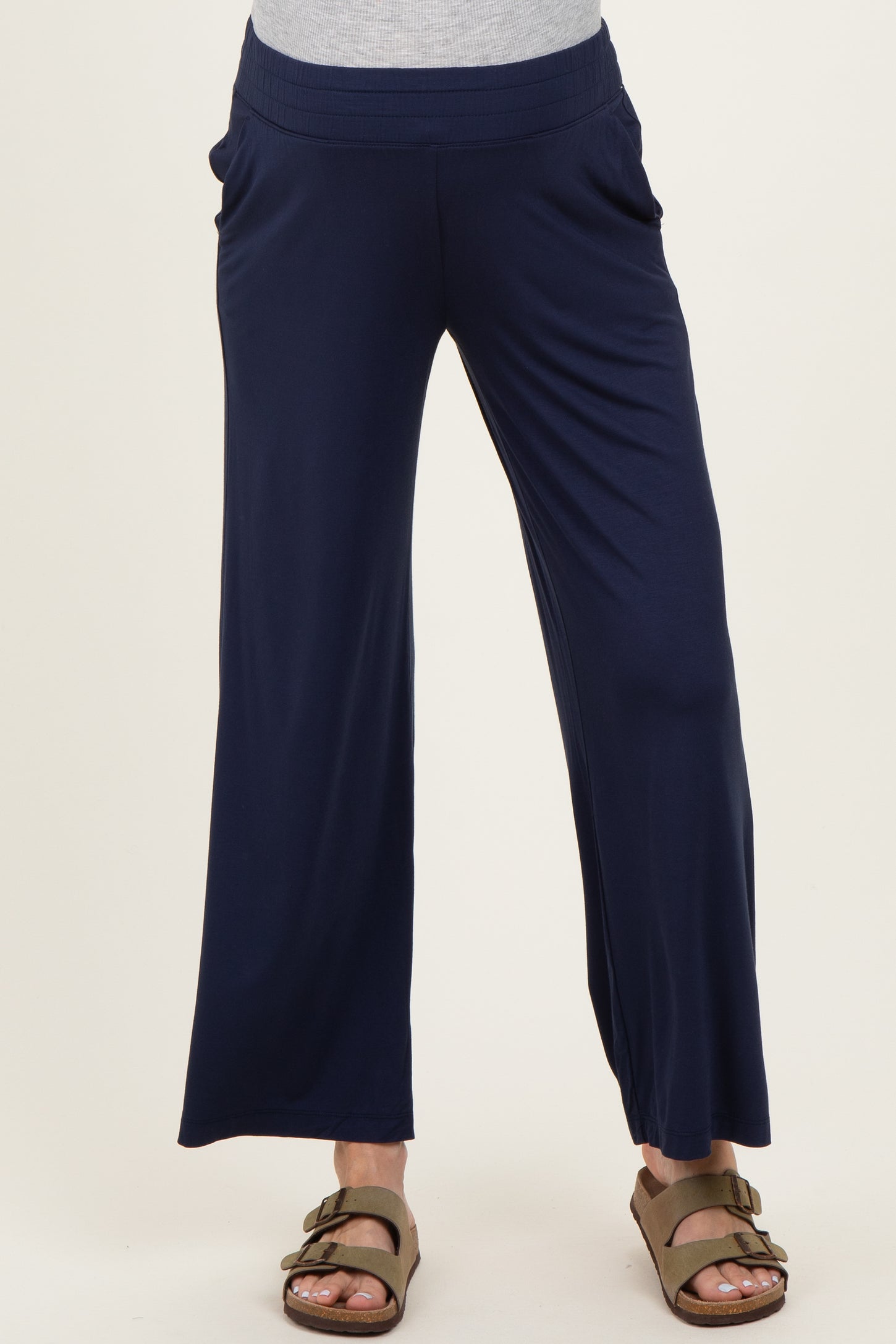 woman wearing navy blue maternity wide-leg pants with side pockets and a stretchy waistband