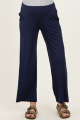 woman wearing navy blue maternity wide-leg pants with side pockets and a stretchy waistband