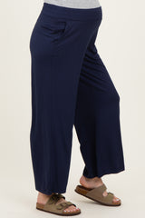 woman wearing navy blue maternity wide-leg pants with side pockets and a comfortable waistband, showing a baby bump