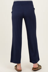 woman wearing navy blue maternity pants with a relaxed fit and wide leg, showing the back view