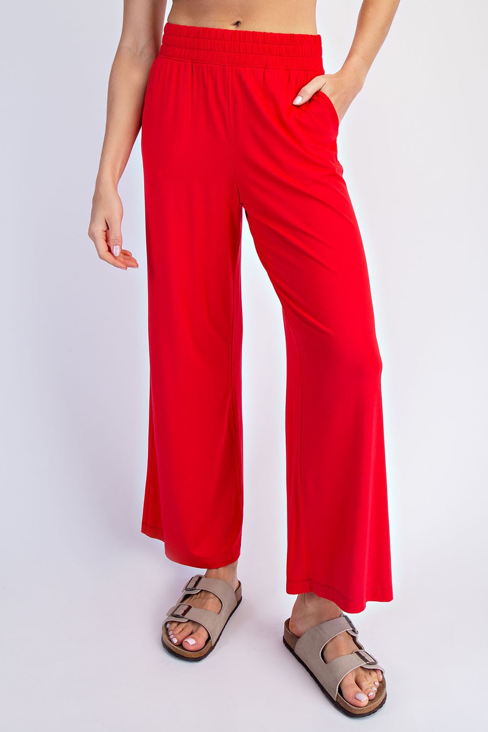 woman wearing bright red wide-leg pants with an elastic waistband and casual sandals