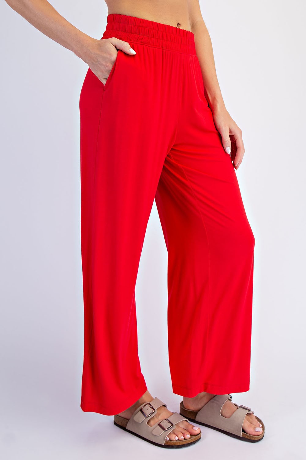 woman wearing bright red wide-leg pants with side pockets and casual sandals