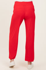 woman wearing bright red maternity pants with a relaxed fit and elastic waistband, seen from the back