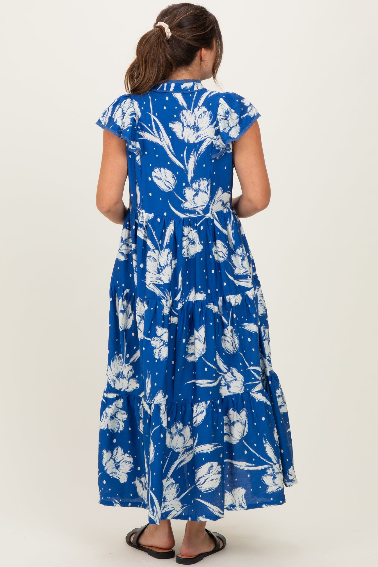 maternity wear blue floral maxi dress with tiered design and short cap sleeves, shown from the back
