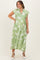 woman wearing a green floral maternity dress with short ruffled sleeves and a tiered skirt, showcasing her baby bump