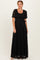 woman wearing a black lace maxi dress with short sleeves and a tie belt at the waist