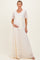 woman wearing a cream lace maternity gown with short sleeves and a tie waist, showing her baby bump