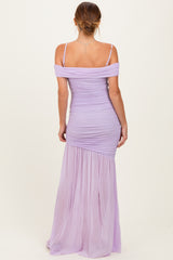 woman wearing a lavender off-the-shoulder ruched maxi dress with a flowing skirt and fitted bodice
