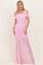 woman wearing a pink off-the-shoulder fitted evening gown with ruched detailing and a flowing skirt