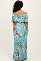woman wearing a turquoise off-the-shoulder floral maxi dress with ruffled sleeves, shown from the back