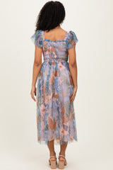woman wearing a floral printed midi dress with puff sleeves and a smocked bodice, viewed from the back
