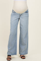 woman wearing light blue wide-leg maternity jeans with a stretchy belly panel