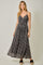 woman wearing a black floral maxi dress with spaghetti straps and a knotted bodice detail