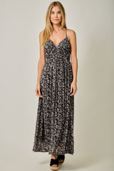 woman wearing a black floral maxi dress with a v-neck and spaghetti straps