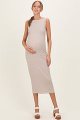 woman wearing a striped maternity dress, showing her baby bump, with a fitted style and sleeveless design